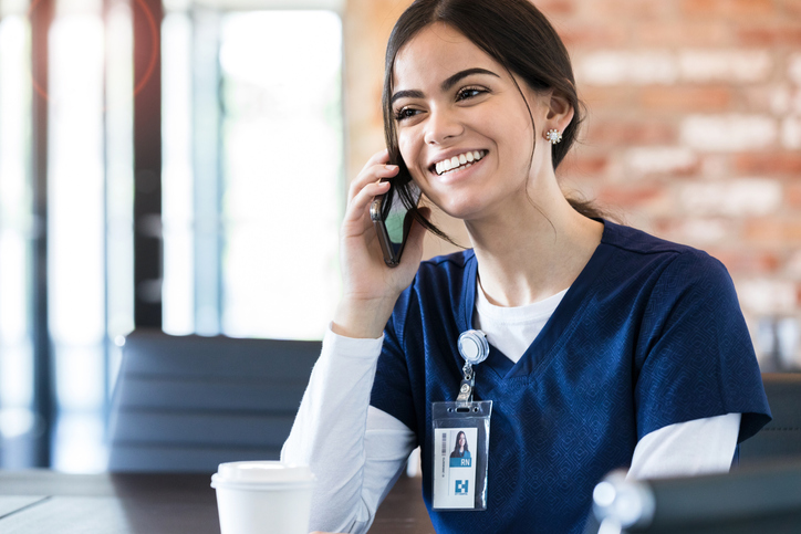 Taking break, nurse talks on smart phone