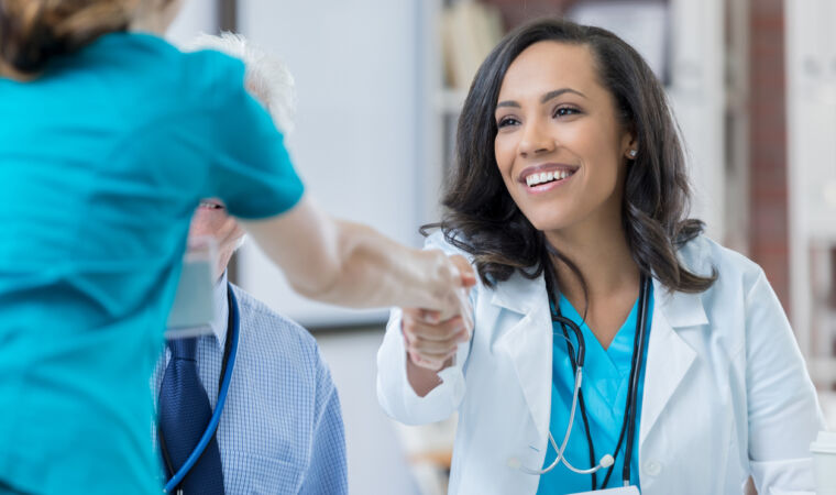 Confident doctor interviews nurse