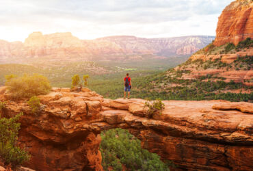 Travel in Devil's Bridge Trail, man Hiker with backpack enjoying view, Sedona, Arizona, USA