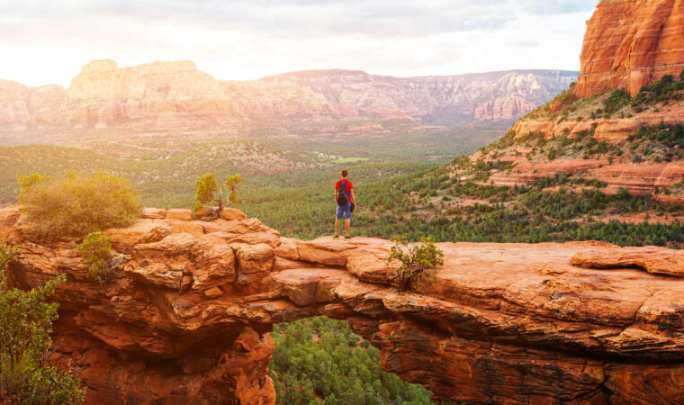 Travel in Devil's Bridge Trail, man Hiker with backpack enjoying view, Sedona, Arizona, USA